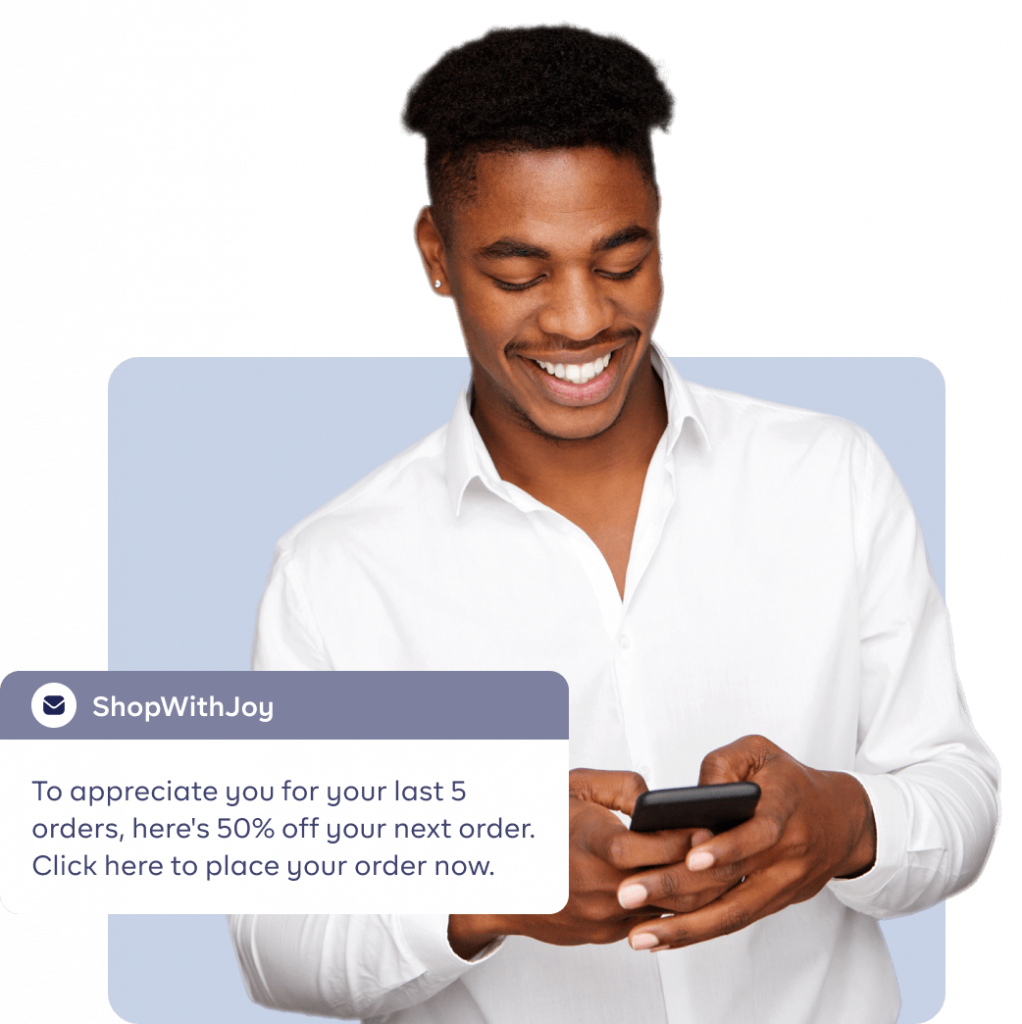 An image of a man pressing his phone smiling